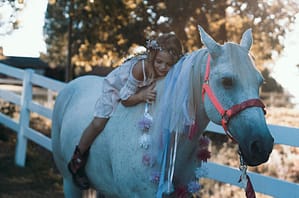 little girl in a white horse