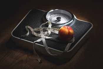 weighing scale, apple and tape measure