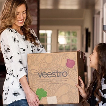 woman carrying a veestro box